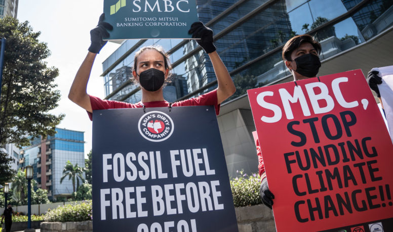 Activists hold a protest in front of Sumitomo Mitsui Banking Corporation (SMBC) office to stop financing fossil fuel in Jakarta.